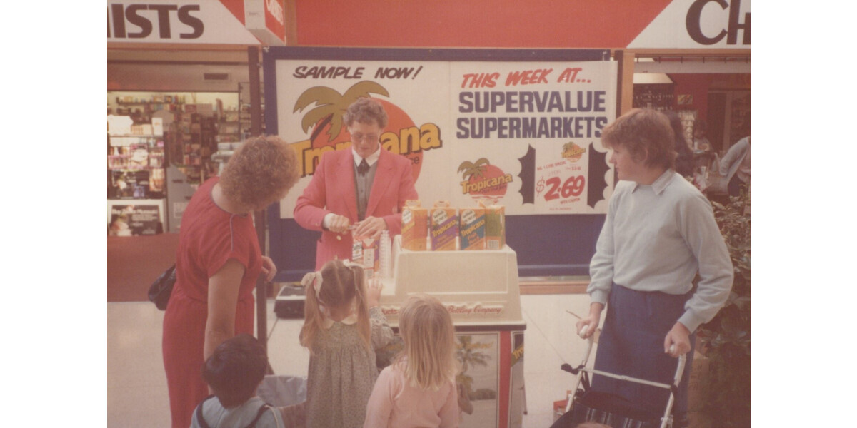 Customers at a Tropicana juice sample stall | discoverywall.nz