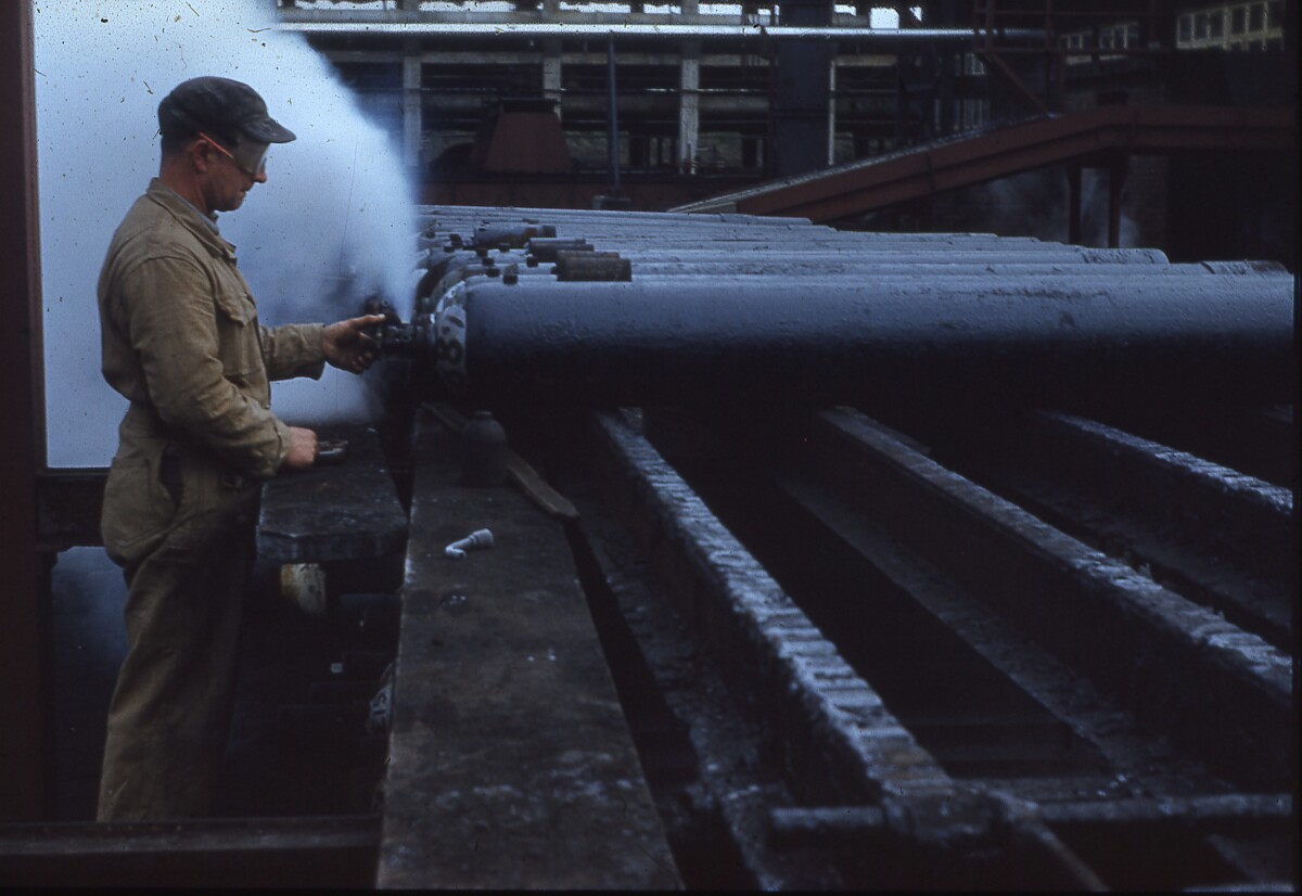 Christchurch gasworks, worker checking cylinder