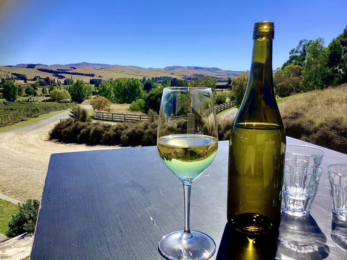 North Canterbury landscape mirrored in a glass of wine