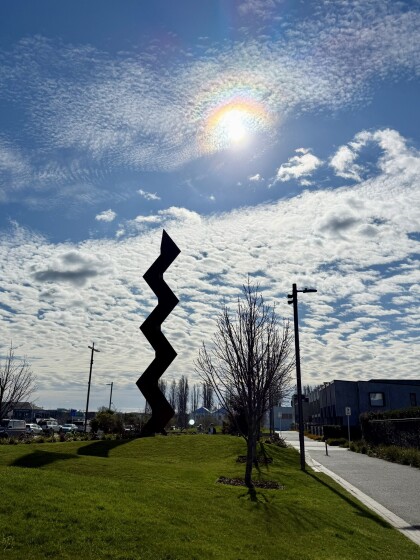 VAKA ‘A HINA sculpture silhouetted against sky
