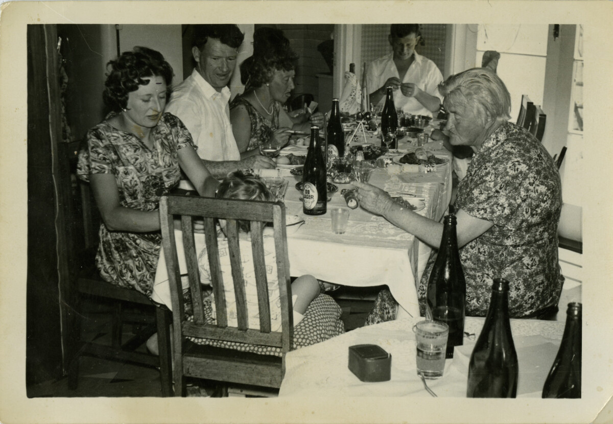 Black and white photo of a family at the Christmas dinner table, 1962