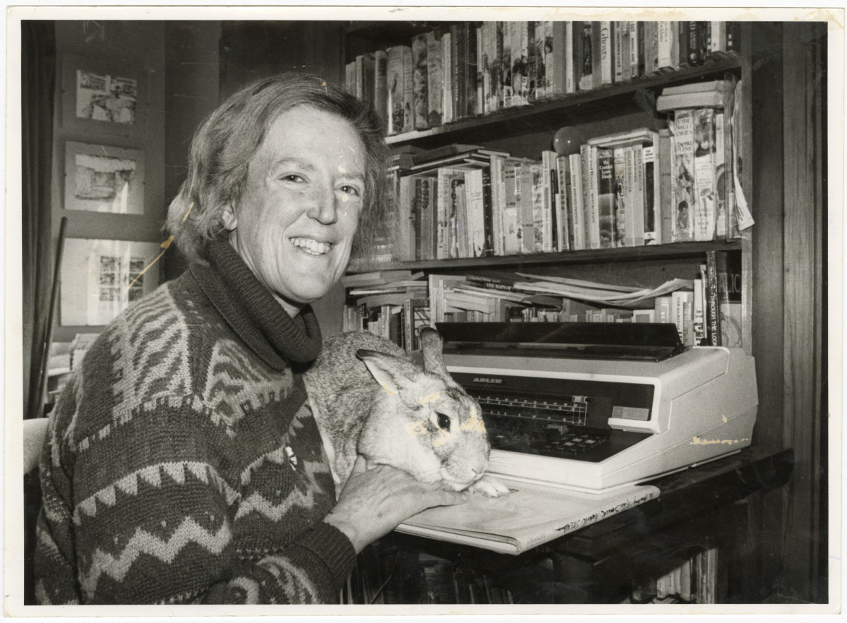 Children's author, Margaret Mahy. 28 June 1983. Portrait of Christchurch children's author, Margaret Mahy at her typewriter with her pet rabbit following her being awarded the Carnegie Medal by the British Library Association for the 