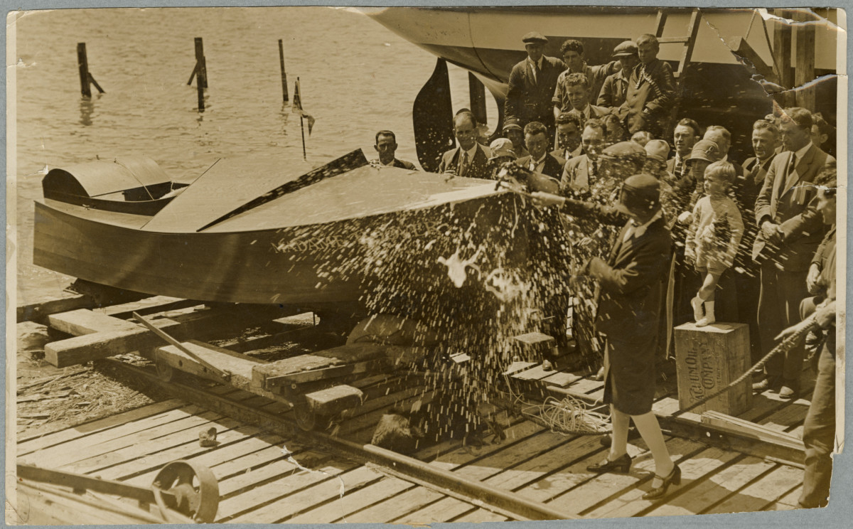 Mrs Elizabeth McCombs christening a motorboat. 23 November 1928. Christchurch Star archive. In copyright. CCL-StarP-00734A